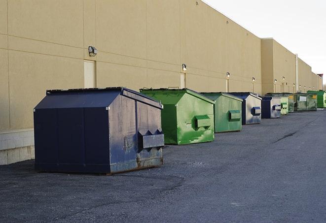 a row of construction dumpsters parked on a jobsite in Adkins